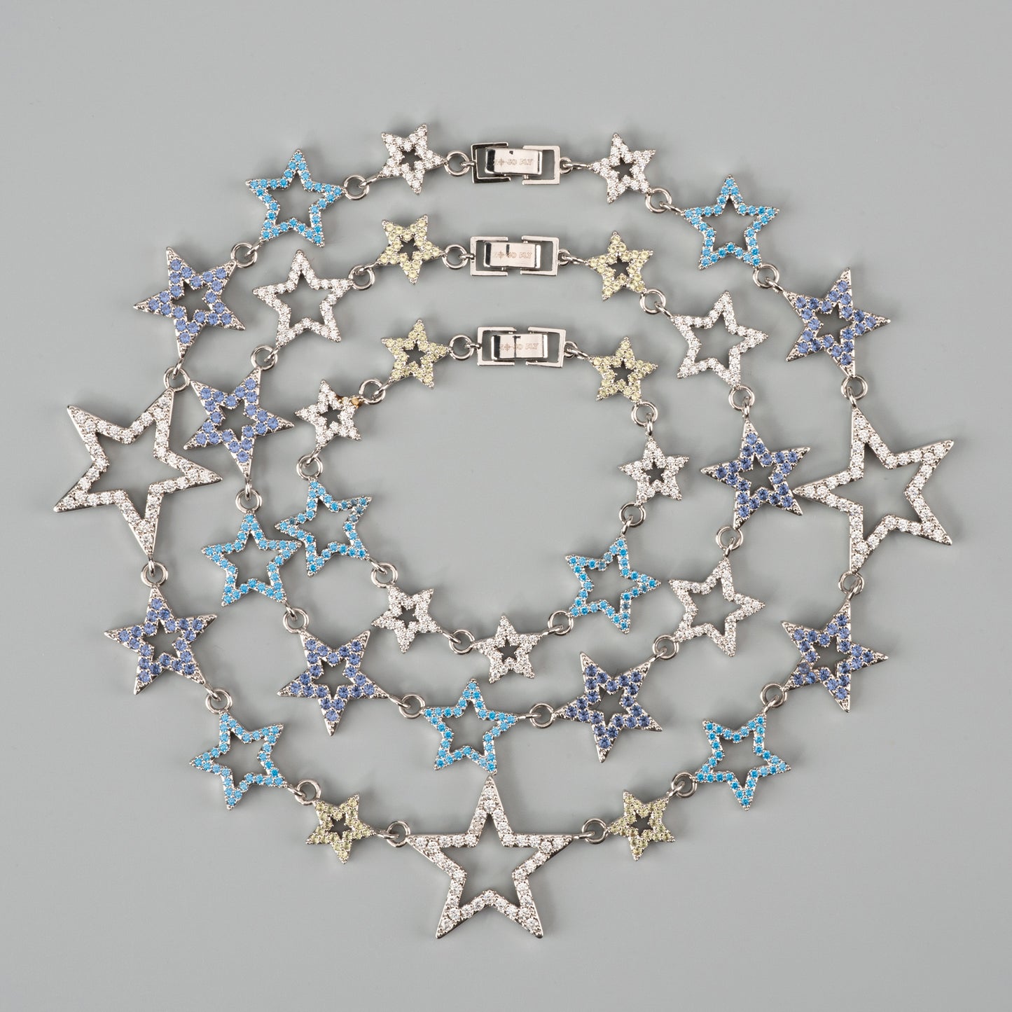 Star-shaped necklace with blue gems on a gray background