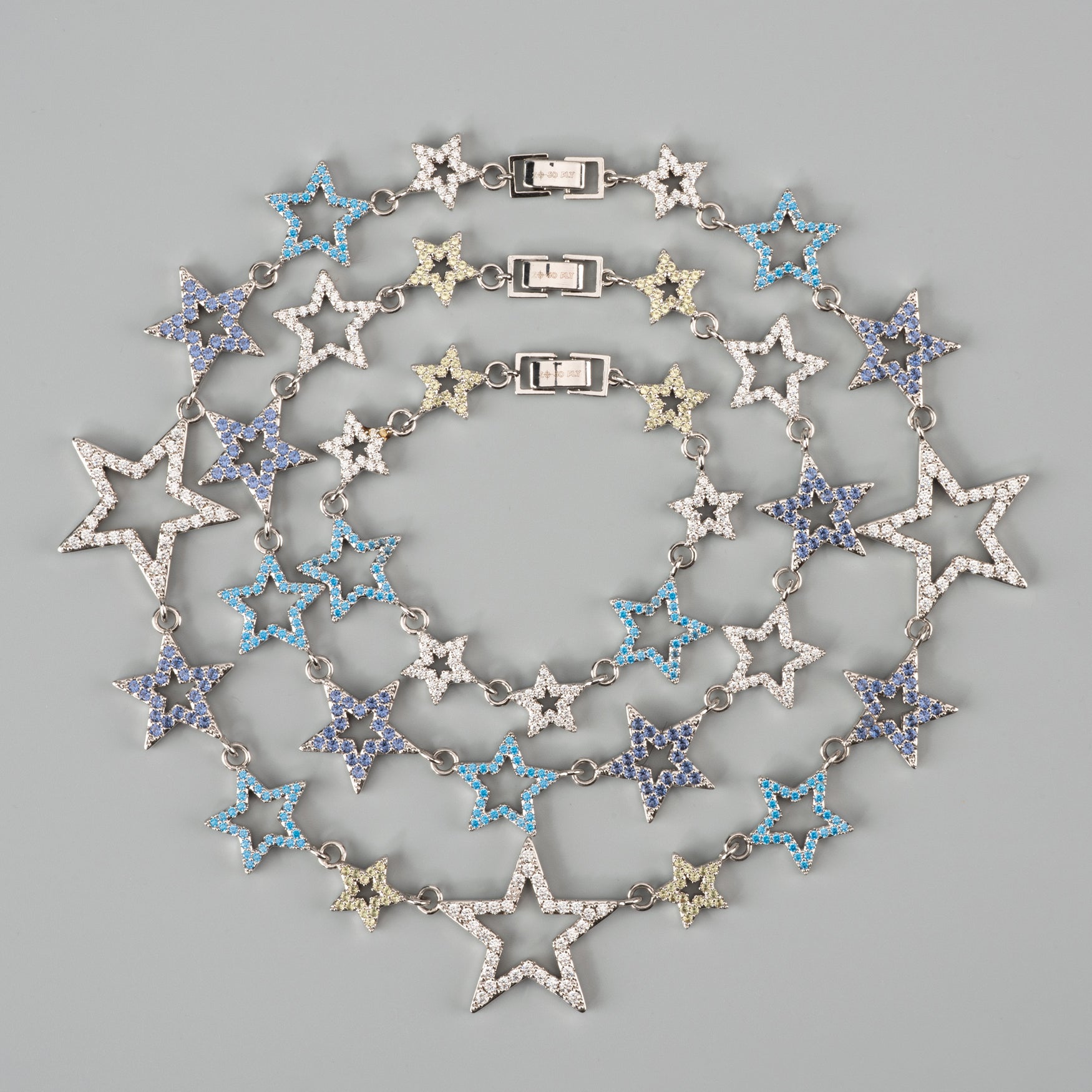 Star-shaped necklace with blue gems on a gray background