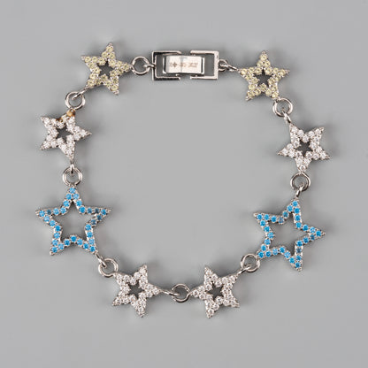 Star-shaped bracelet and collar with blue and clear gemstones on a gray background